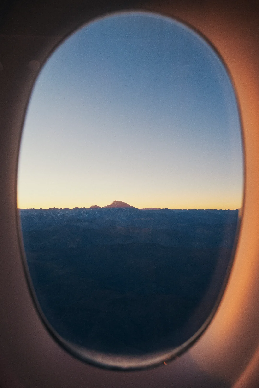 Aconcagua sunrise, summit halo against gradient sky, cordillera unspooling below.