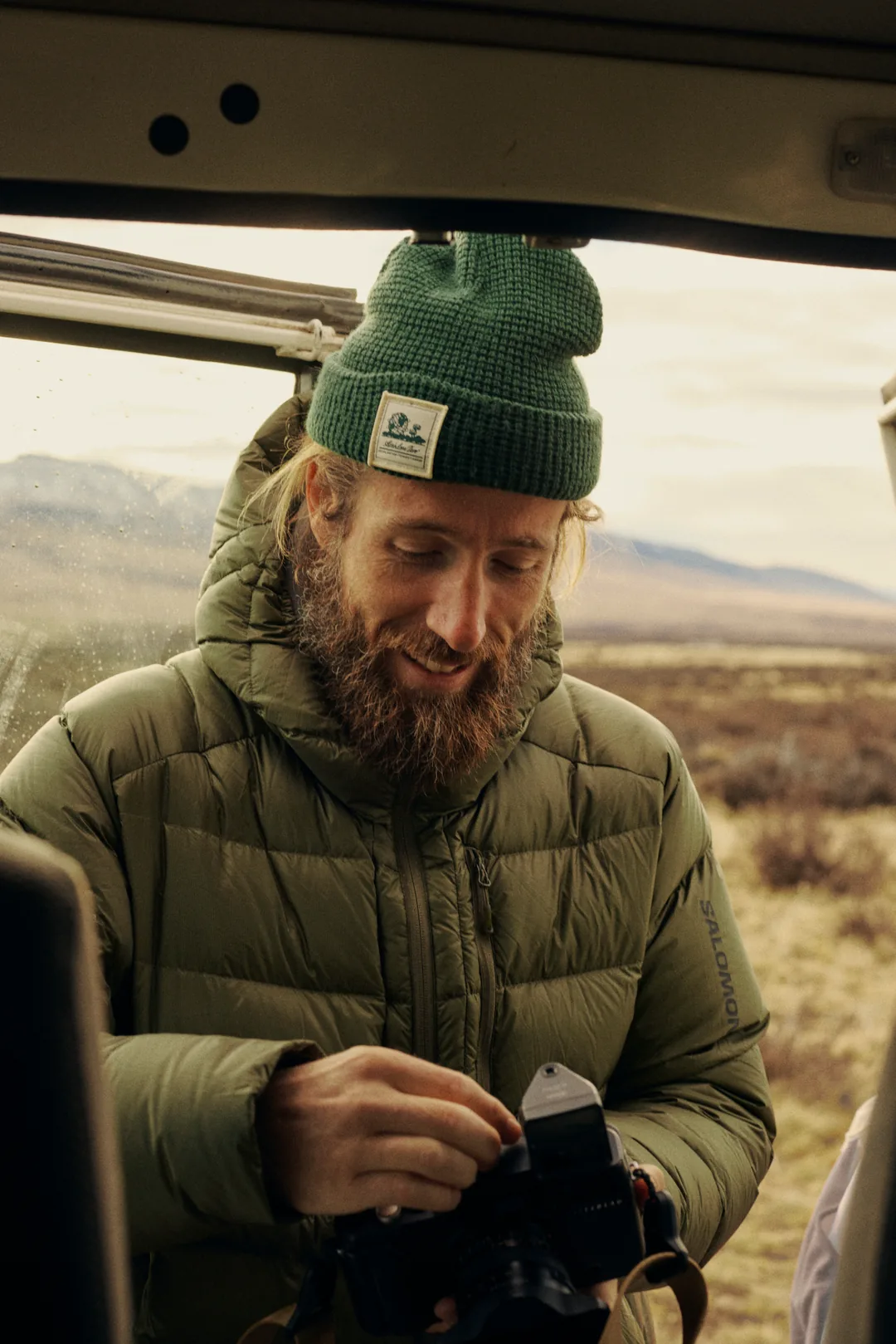 Alex Strohl loading film into a medium-format camera inside the truck